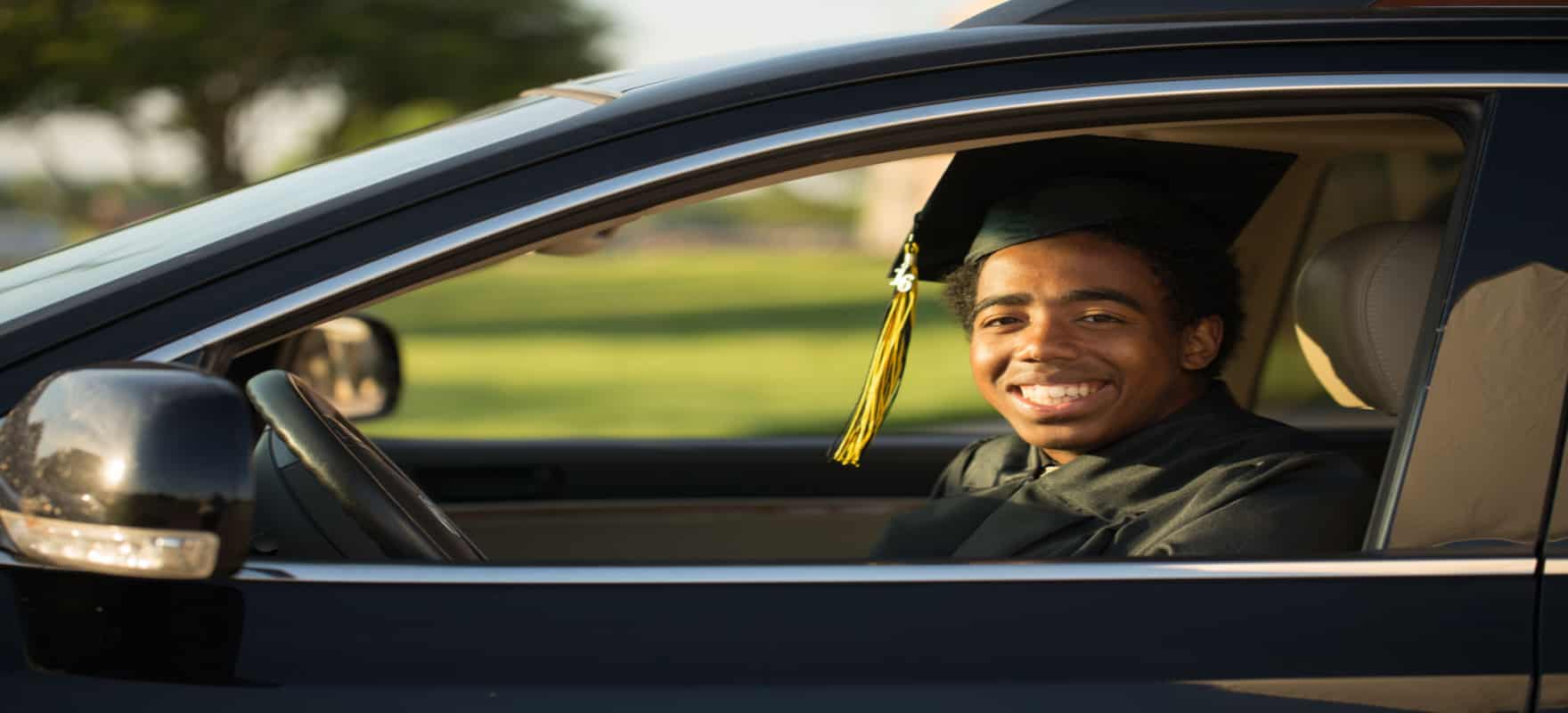 college graduate in his car