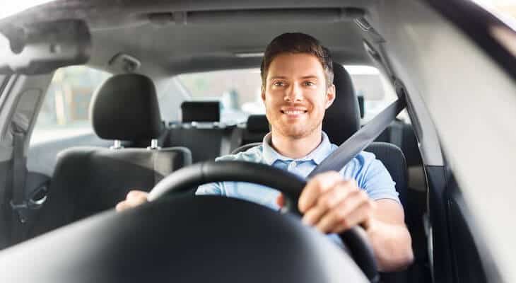 Man happily driving a car