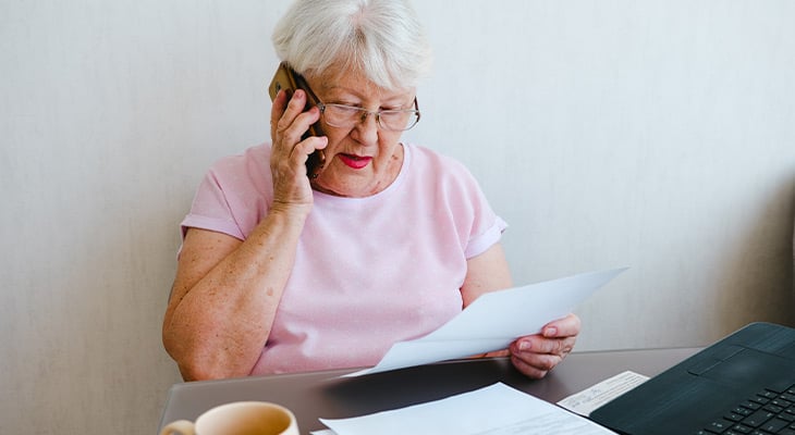 older woman on the phone with car insurance company