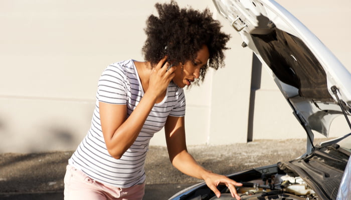 woman having car problems on the phone with her roadside assistance company (1)