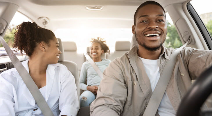 Infinity auto insurance: family happily traveling using their car