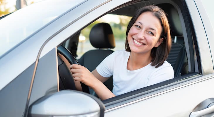 Elephant auto insurance: smiling woman inside her car