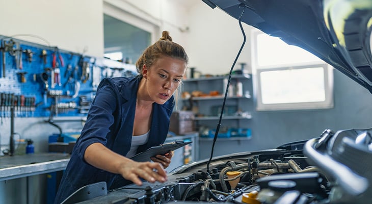 woman repairing a vehicle