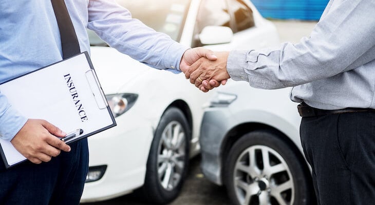 Transgender car insurance: insurance agent shaking hands with his client