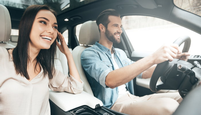 man and woman smiling in the car 