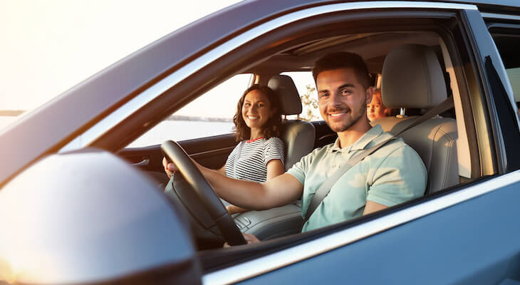 Gender neutral car insurance: family happily traveling using their car