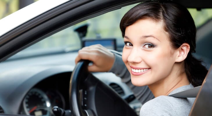 Esurance quote: person smiling while driving her car