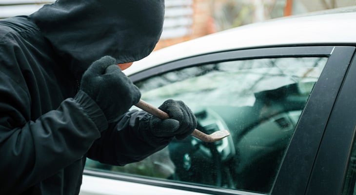 person breaking into a vehicle