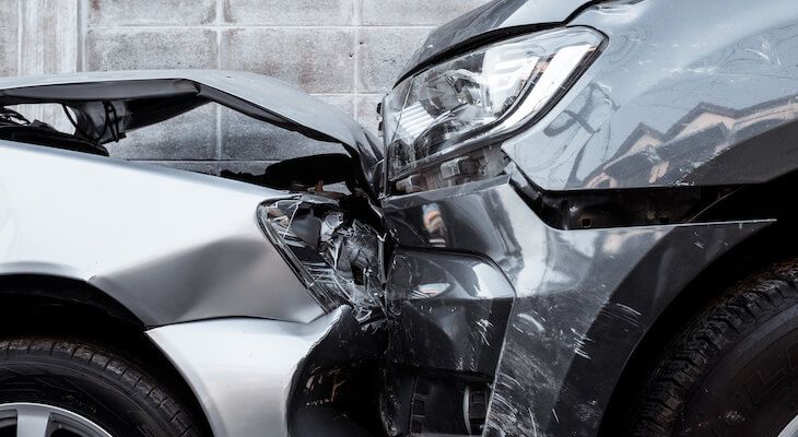 New car replacement insurance: close up shot of cars that crashed into each other