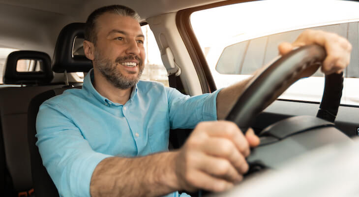 Man happily driving a car