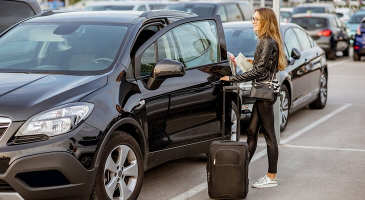 Rental reimbursement: woman opening the door of a car