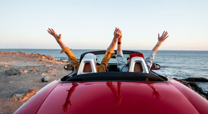 Car insurance for married couples: couple parked near the beach