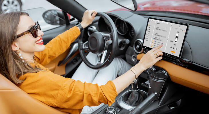 Woman checking her car's digital screen