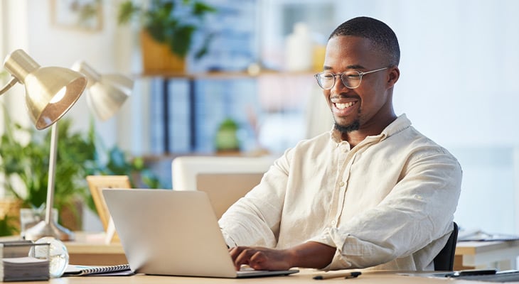 Man on laptop looking at auto insurance quotes
