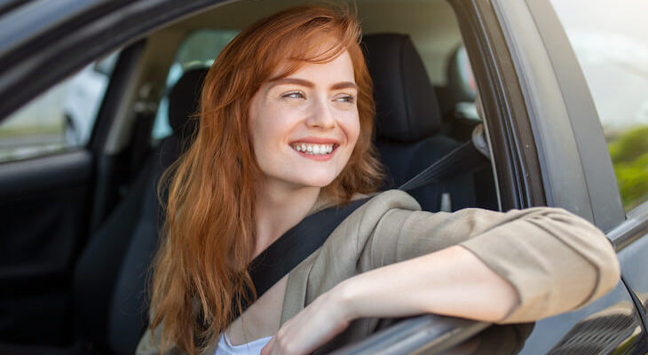 Woman happily riding a car