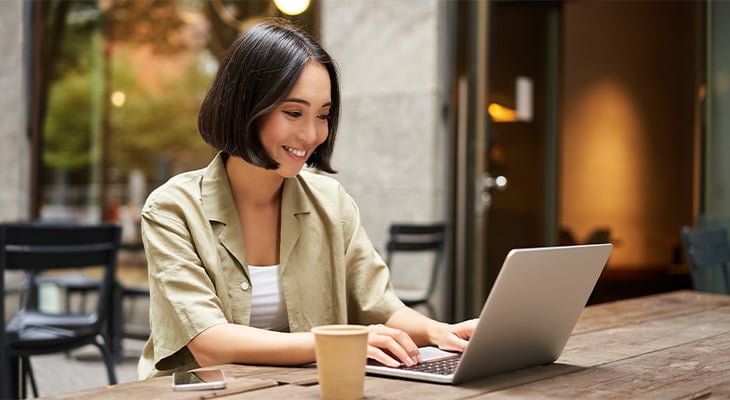Woman on laptop looking at car insurance companies