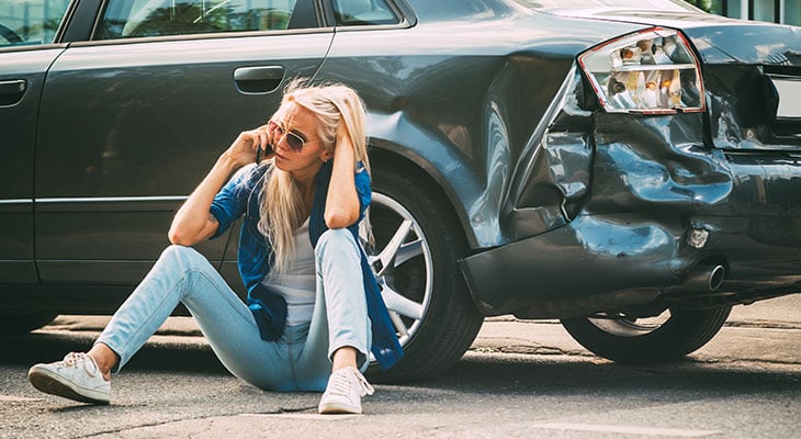 Woman on the phone with her insurance company after an accident