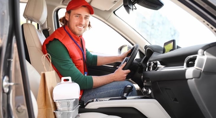 Delivery driver insurance: delivery man driving a car