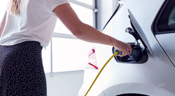 How much to lease a Tesla: Woman charging her electric car