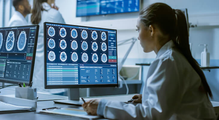 How much does a CT scan cost: doctor analyzing brain scans