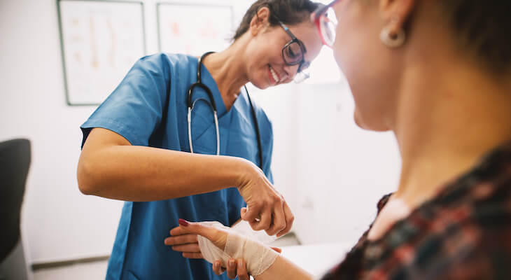 How to negotiate medical bills: doctor putting a bandage on a patient's wrist