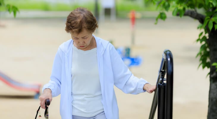 Hip replacement cost: Older woman walks up steps