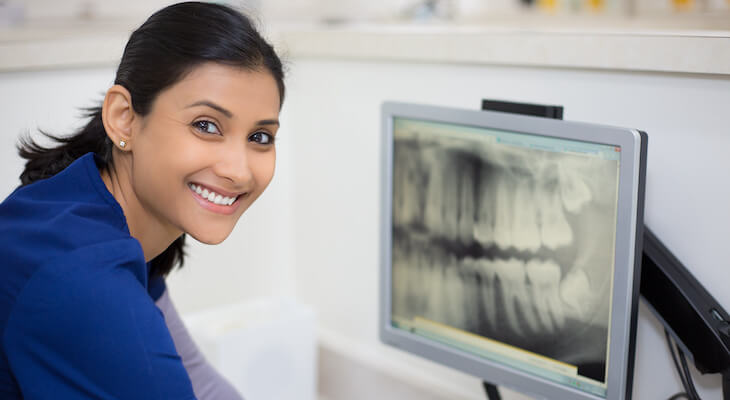 How much is a root canal: dentist showing a dental X-ray