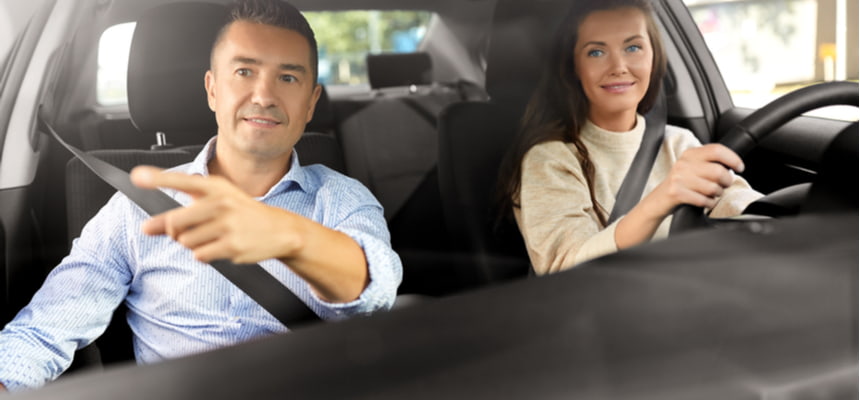 man and woman driving with the cheapest car insurance in Minnesota 
