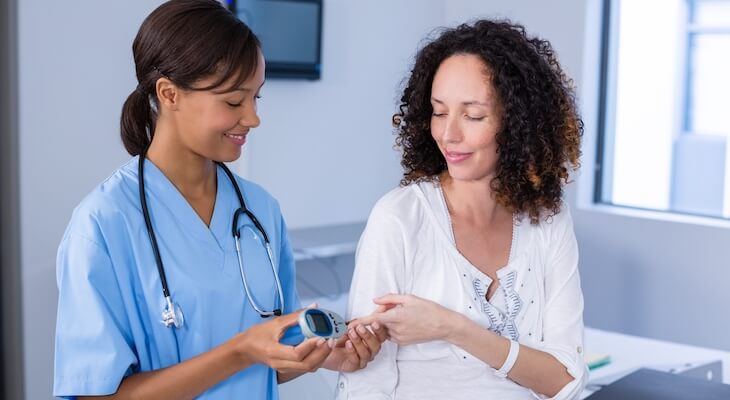 Cost of diabetes: doctor testing her patient
