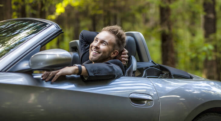 Electric convertible cars: happy man in his convertible car