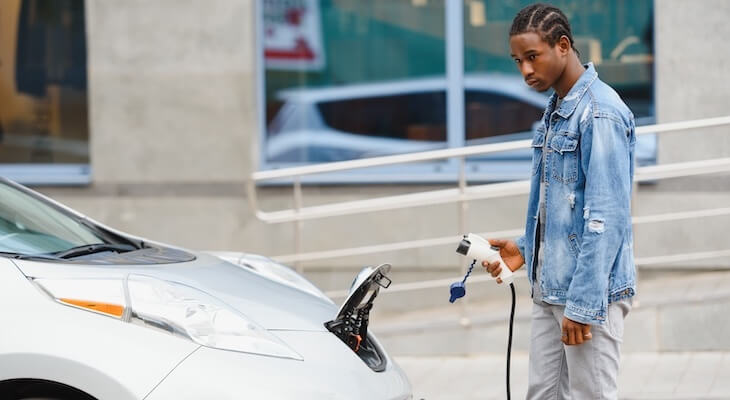EV CPO: man holding an EV charging