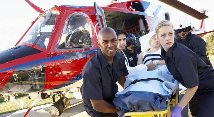 Paramedics unloading a patient from a helicopter