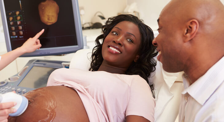 Pregnant woman with her husband getting a 4D ultrasound