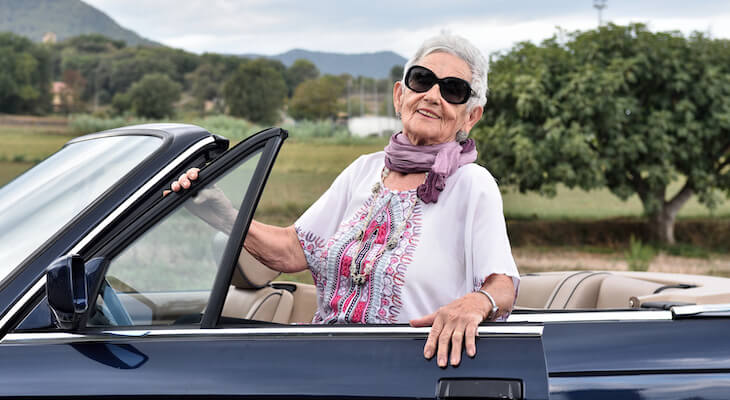 Electric convertible cars: elderly woman in her convertible car