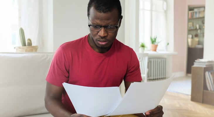 Worried man looking at documents