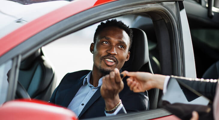 Tesla depreciation: man in his car talking to someone