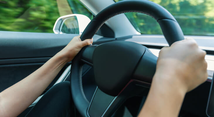 Close-up of hands on a steering wheel
