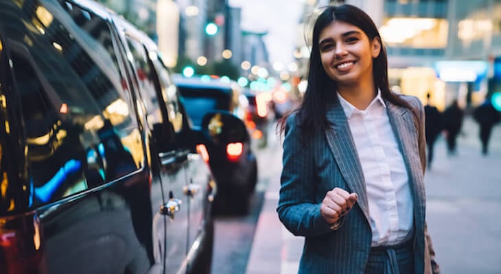 Cheapest SUV to insure: happy entrepreneur walking outside