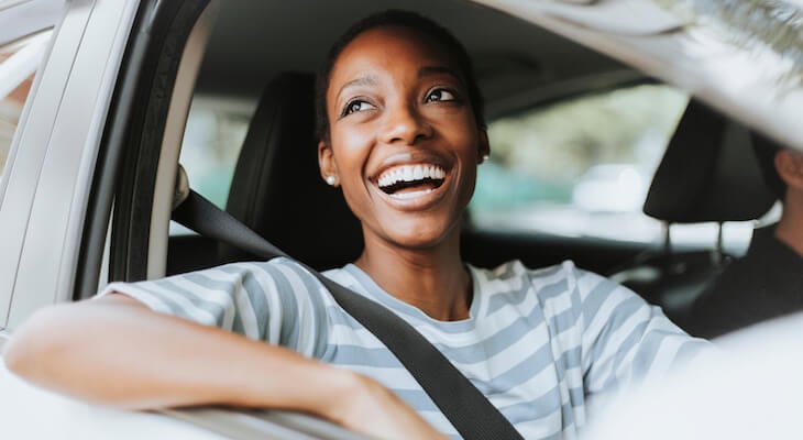 Happy woman inside a car
