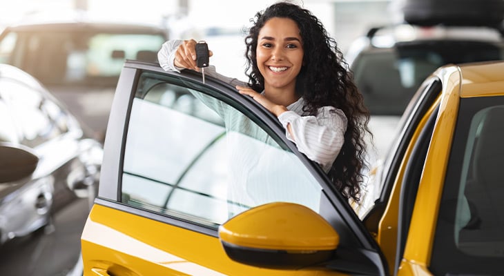 Woman holding the keys to a new car