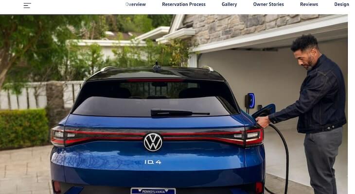vw id4 vs tesla model y: man plugging car into electric charger