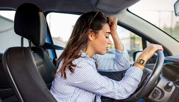 woman stressed about cost of car insurance in 2022