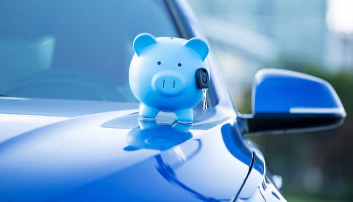 piggie bank on vehicle to represent saving money on car insurance policy