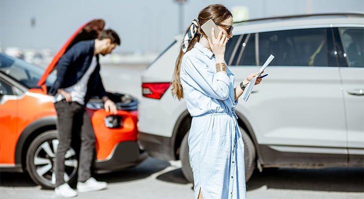 woman on the phone after auto accident