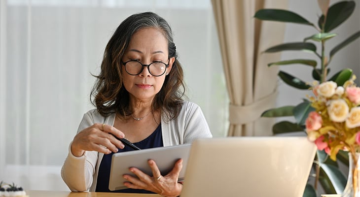 older woman looking at car insurance companies online