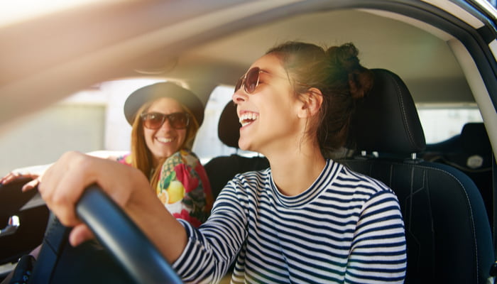 two women laughing in the car
