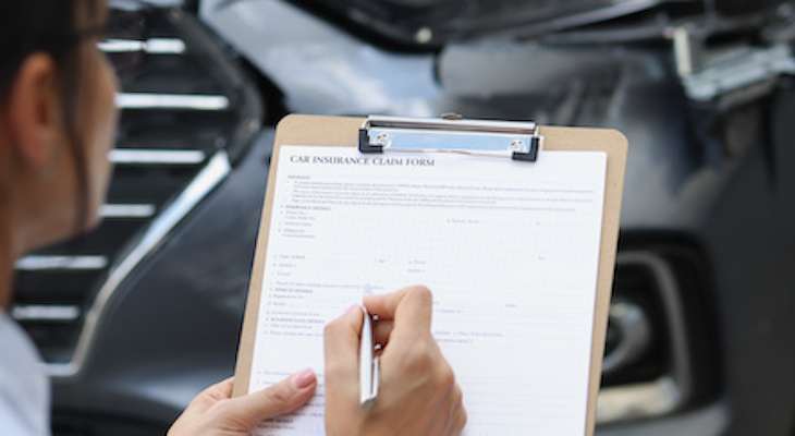 How much is gap insurance: woman filling-out some insurance forms