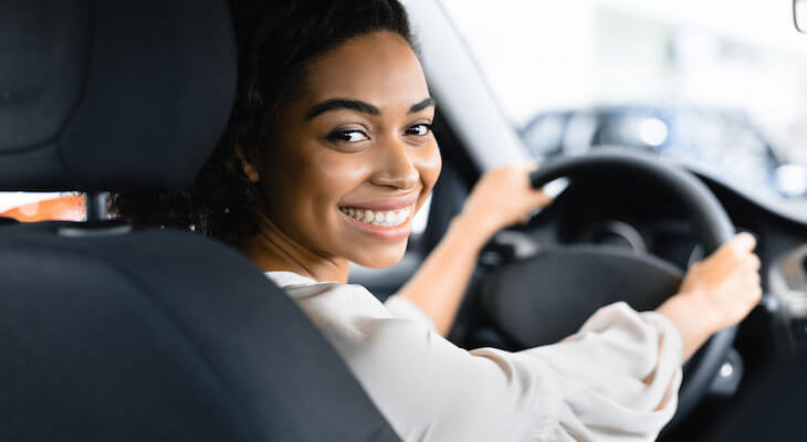 When does gap insurance not pay: woman happily driving a car