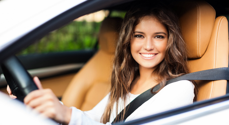 Woman happily driving a car