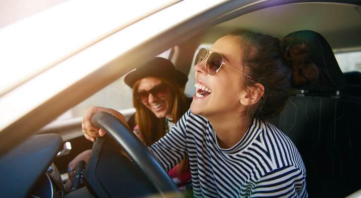 Best car insurance for young drivers: friends happily riding a car